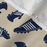 navy soccer cleats on tan - soccer shoes - LAD19