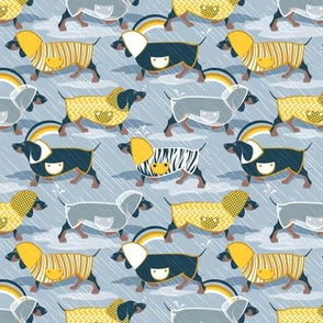 Tiny scale // April showers frenzy // pastel blue background navy blue dachshunds dogs with yellow and transparent rain coats