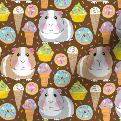 guinea pigs with sprinkle cookies, donuts, cupcakes and ice cream on brown