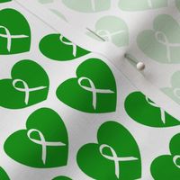 Awareness ribbons in green hearts for genetic disorders