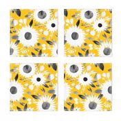 white and black sunflowers on mustard