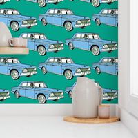 pale blue 1964 1965 Studebaker Lark Cruiser on teal background