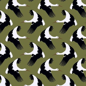 Storks in flight on olive green 3”