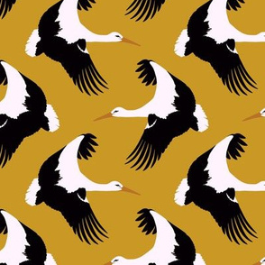 Storks in flight on mustard 4.5”