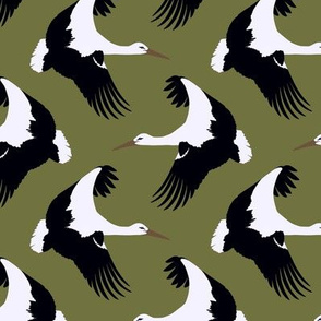Storks in flight on olive green 4.5”