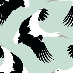 Storks in flight on robins egg blue 10.5”