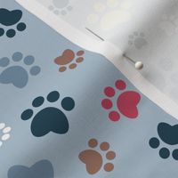 Small scale // Paw prints // pastel blue background white blue yellow red brown and navy blue animal foot prints