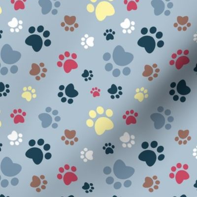 Small scale // Paw prints // pastel blue background white blue yellow red brown and navy blue animal foot prints