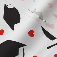 Tossed Graduation Caps with Red Heart Confetti