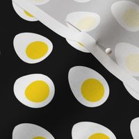 Small Yellow and White Hard Boiled Eggs on Black