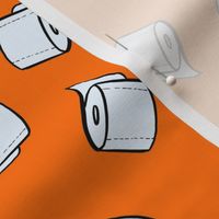 Toilet paper tissue rolls on bright orange
