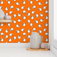 Toilet paper tissue rolls on bright orange