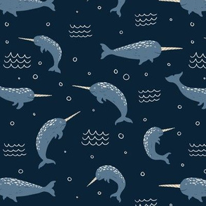 Narwhals in the ocean on a dark blue