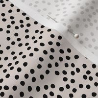Irregular minimal spots and dots cheetah animal print nursery trend off white black