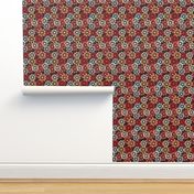 Stylized red, blue, and yellow flowers against a chocolate background.