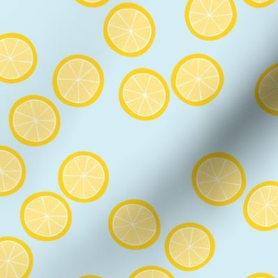 Little slices of lemon bright yellow fruit cocktail summer design on blue