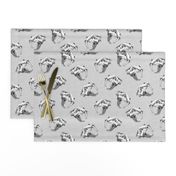 Scattered Sabre Tooth Tiger Skulls on Grey Linen