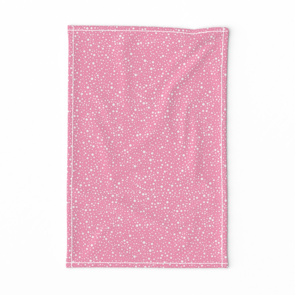 White polka dots on a pink background