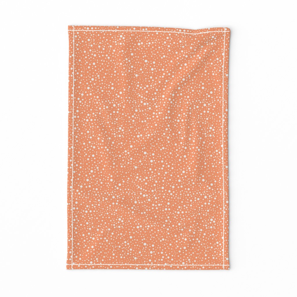 White polka dots on a bright orange background