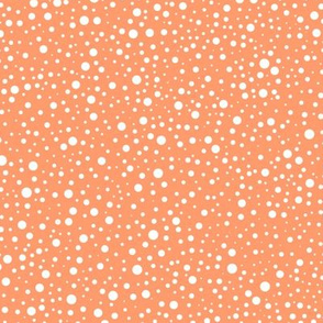 White polka dots on a bright orange background