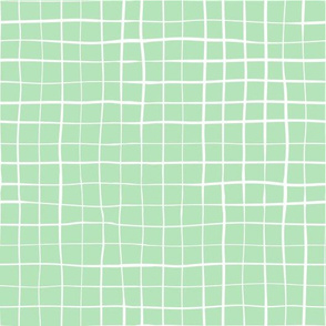 White lines crisscrossed on a mint green background